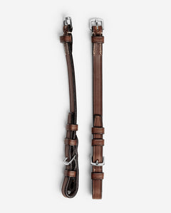 Pair of brown leather straps with silver hardware on a white background