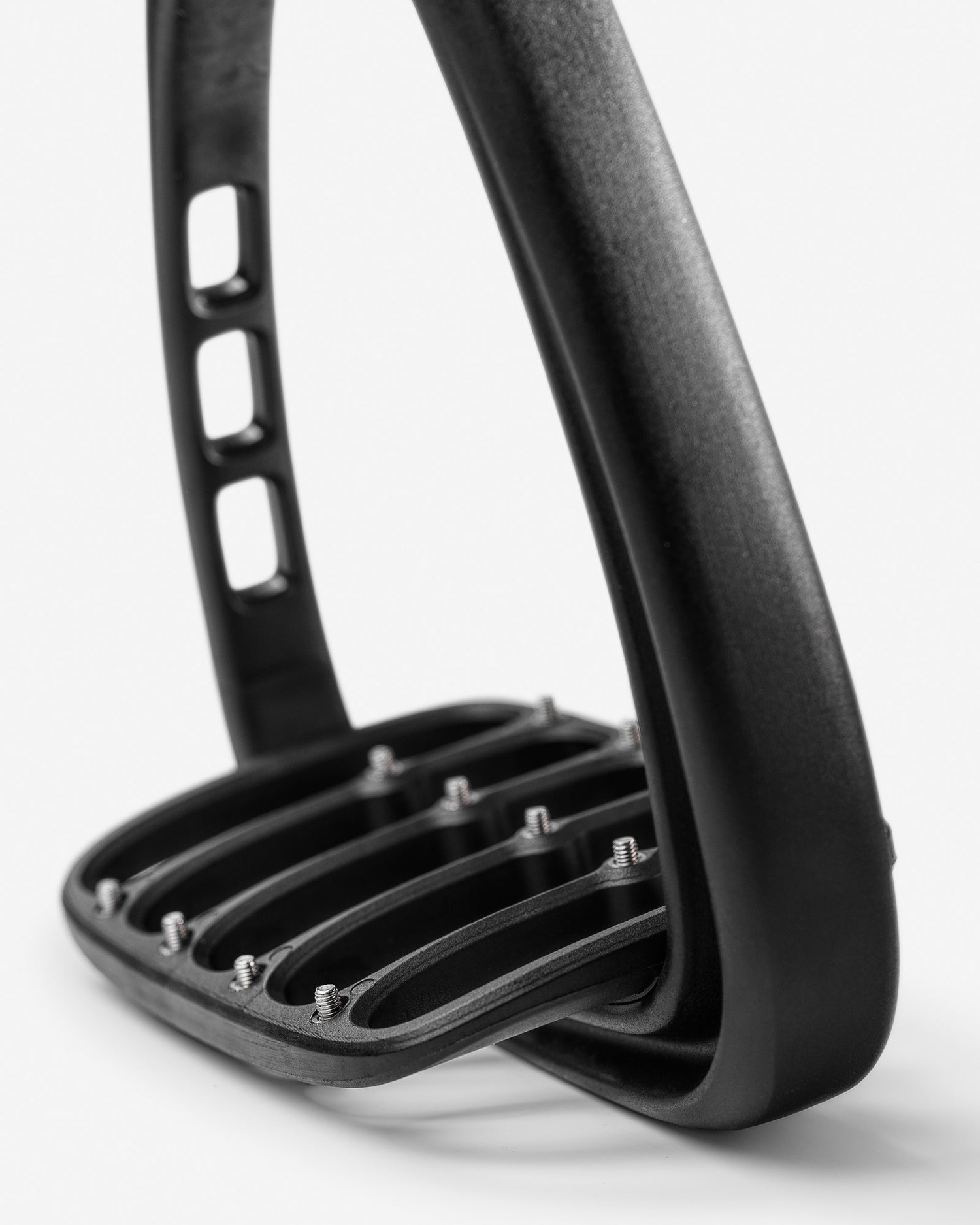 Close-up of a black metal stirrup on a white background
