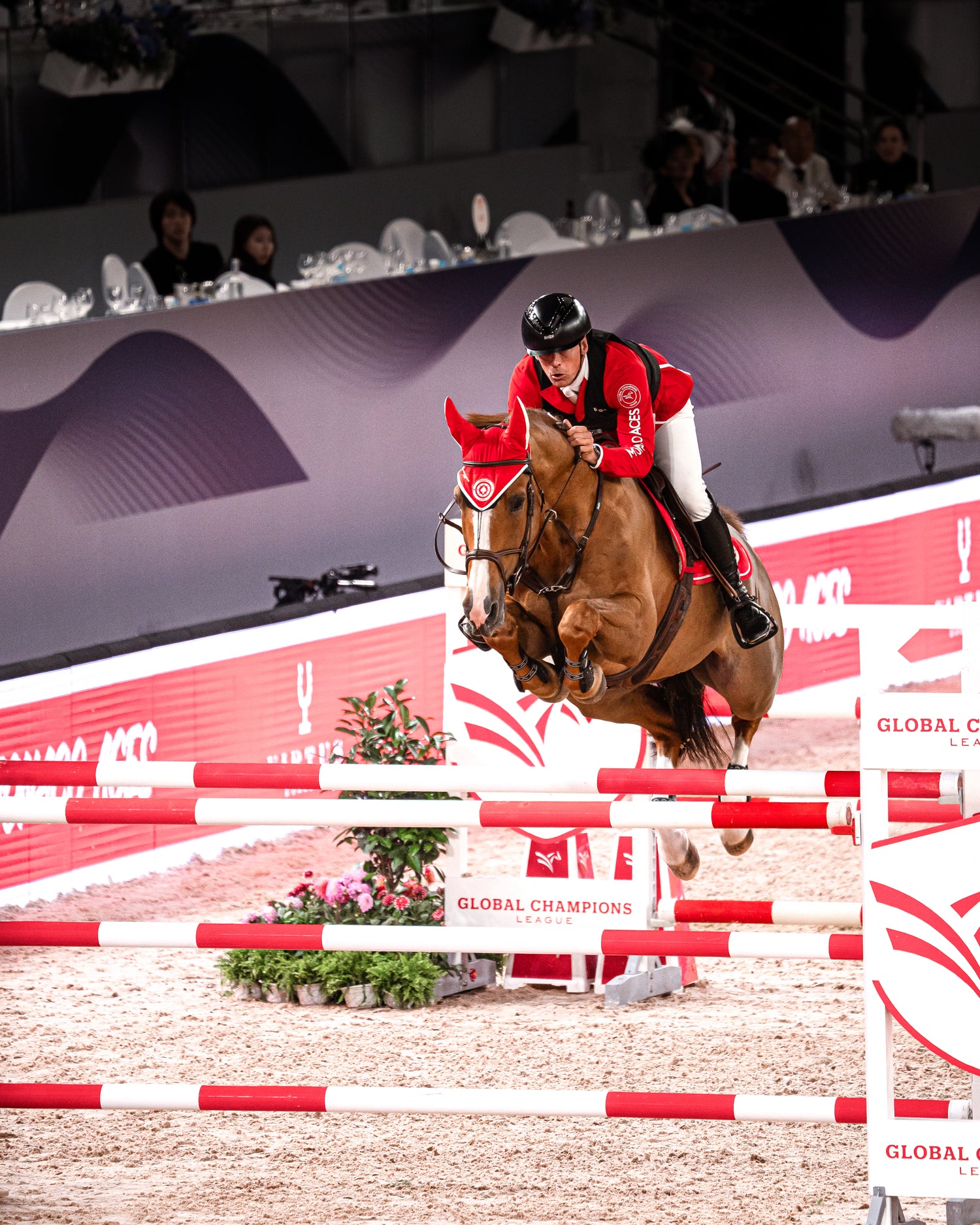 Horse and rider jumping over an obstacle at a equestrian competition.