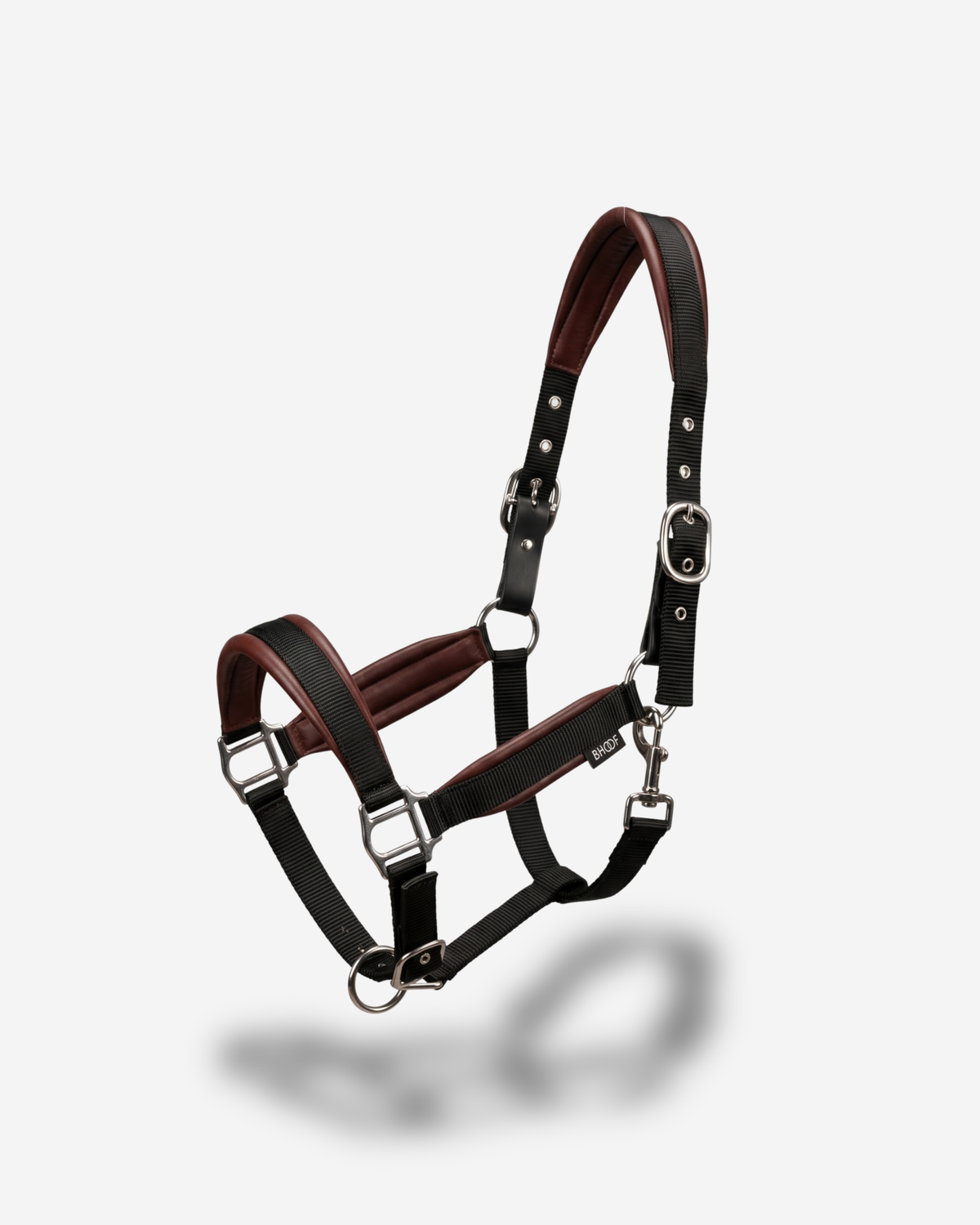 Brown and black leather horse halter on a white background